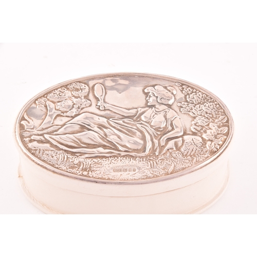 140 - An Elizabeth II silver topped leather trinket box with embossed design of a classical reclining lady... 