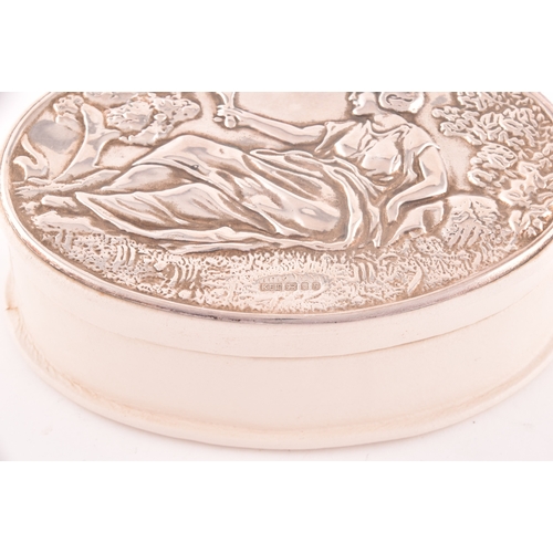 140 - An Elizabeth II silver topped leather trinket box with embossed design of a classical reclining lady... 