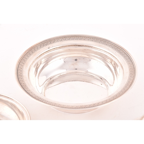 141 - A silver three piece caviar serving lidded dish, with inside tray, set with a decorative floral top ... 