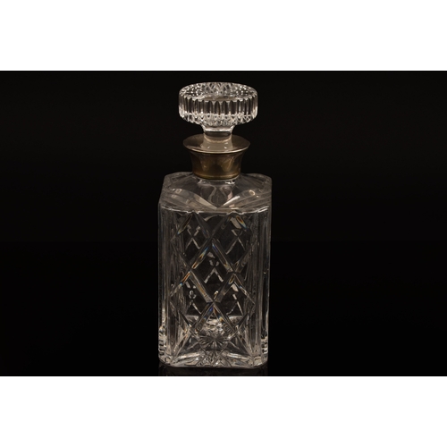 142 - A silver mounted cut crystal glass whisky decanter and stopper, with silver mounted collar, hallmark... 