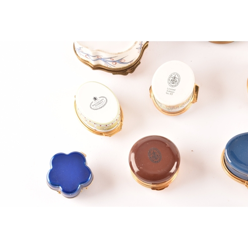 87 - A collection of enamel pill boxes of varying shapes and sizes, including maker's such as Halcyon Day... 