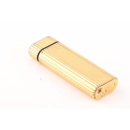 89 - A Cartier gold plated ribbed cigarette lighter, signed Cartier and numbered A44844 to the base, toge... 