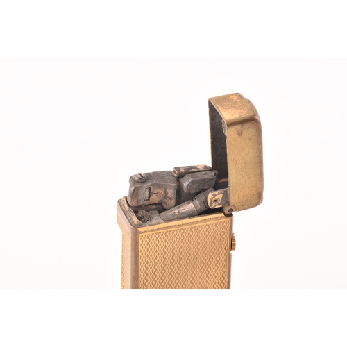 89 - A Cartier gold plated ribbed cigarette lighter, signed Cartier and numbered A44844 to the base, toge... 