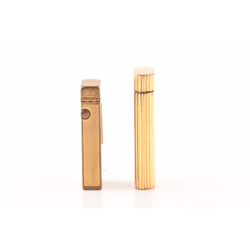 89 - A Cartier gold plated ribbed cigarette lighter, signed Cartier and numbered A44844 to the base, toge... 