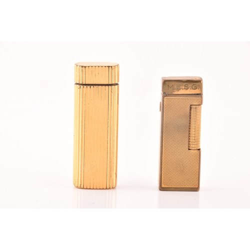 89 - A Cartier gold plated ribbed cigarette lighter, signed Cartier and numbered A44844 to the base, toge... 