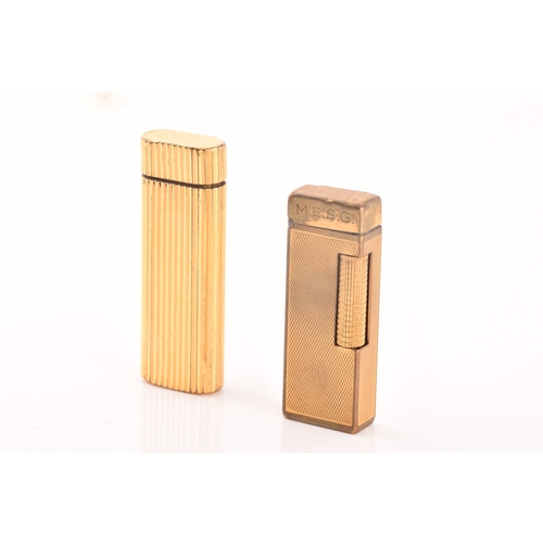 89 - A Cartier gold plated ribbed cigarette lighter, signed Cartier and numbered A44844 to the base, toge... 