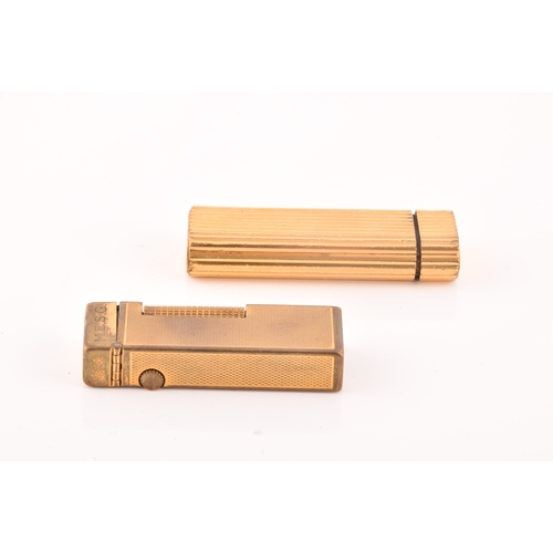 89 - A Cartier gold plated ribbed cigarette lighter, signed Cartier and numbered A44844 to the base, toge... 