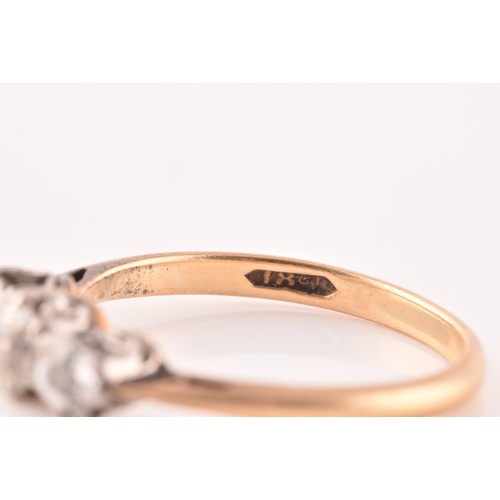 40 - A 18ct yellow gold and platinum three stone diamond ring, set with three round old cut diamonds, wit... 