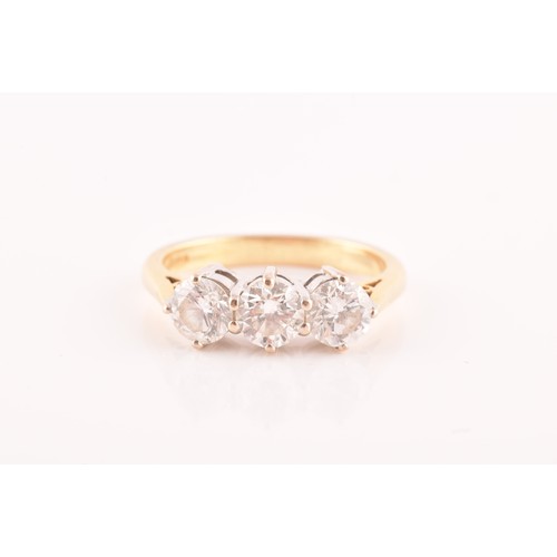 40 - A 18ct yellow gold and platinum three stone diamond ring, set with three round old cut diamonds, wit... 