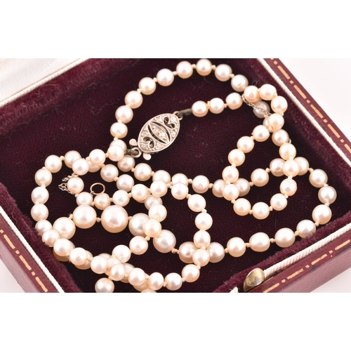 41 - A graduated pearl necklace, pearls measuring 3.4mm to 6.0mm, the white metal clasp set with old cut ... 