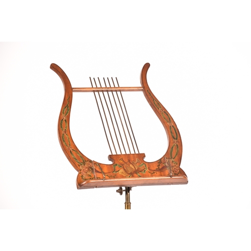 302 - An Edwardian Sheraton revival painted satinwood adjustable music stand, painted with musical instrum... 