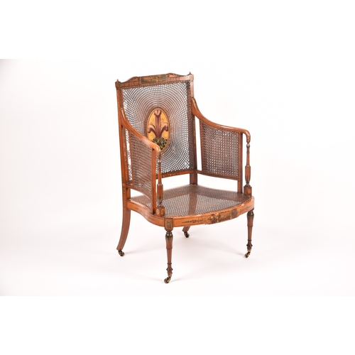 303 - An Edwardian Sheraton revival bergere armchair, the top rail painted with a scene of children playin... 