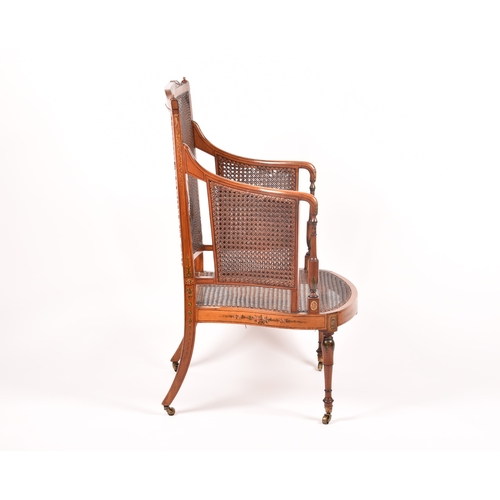 303 - An Edwardian Sheraton revival bergere armchair, the top rail painted with a scene of children playin... 