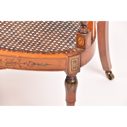 303 - An Edwardian Sheraton revival bergere armchair, the top rail painted with a scene of children playin... 