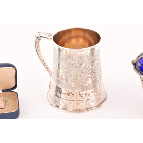 152 - A collection of antique silver, including a Victorian aesthetic movement tankard, engraved with bird... 