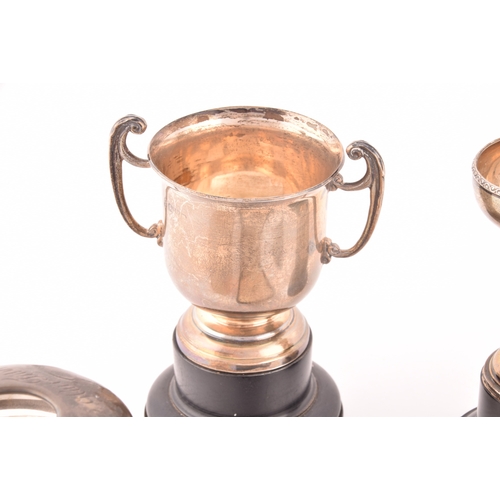 154 - A collection of assorted silver items including four miniature trophy cups on stands, three 19th cen... 