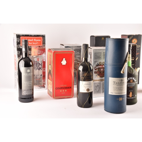 320 - An assortment of alcohol, including two boxed bottles of Chivas Regal whisky, one cased bottle of Ta... 