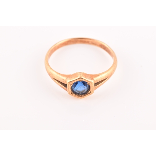 47 - A yellow metal solitaire ring, set with a round old cut sapphire with an approximate weight of 0.60 ... 