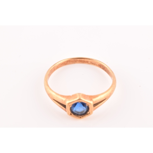 47 - A yellow metal solitaire ring, set with a round old cut sapphire with an approximate weight of 0.60 ... 