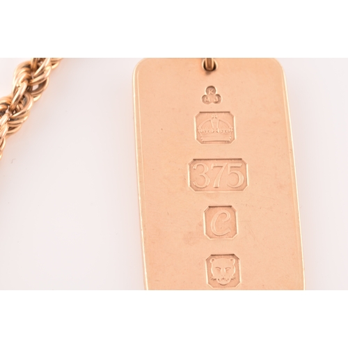 50 - A 9ct yellow gold ingot, hallmarked for London 1977 by K M J, on a 14ct yellow gold twisted rope cha... 