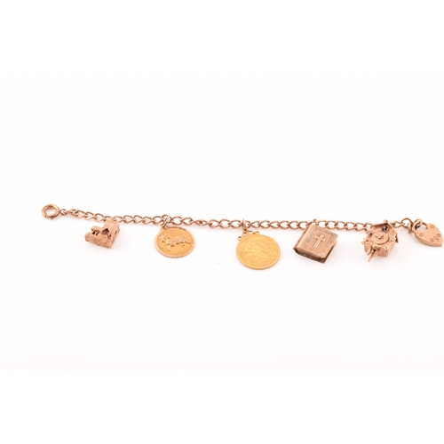 52 - A 9ct rose gold charm bracelet, suspended with three 9ct yellow gold charms, two rose metal charms, ... 