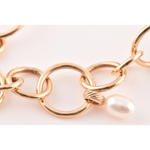 54 - A 9ct yellow gold and pearl hoop link bracelet, together with a pair of matching 9ct yellow gold and... 