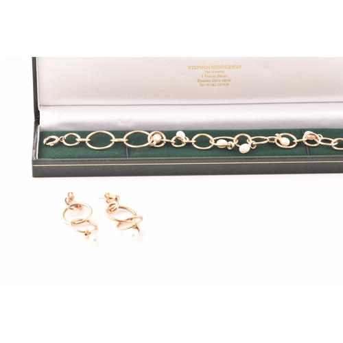 54 - A 9ct yellow gold and pearl hoop link bracelet, together with a pair of matching 9ct yellow gold and... 