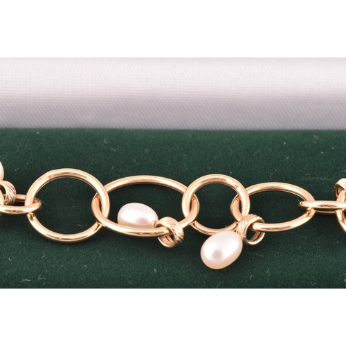 54 - A 9ct yellow gold and pearl hoop link bracelet, together with a pair of matching 9ct yellow gold and... 