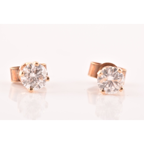 55 - A pair of 14ct yellow gold diamond studs, featuring brilliant cut diamonds with a combined approxima... 