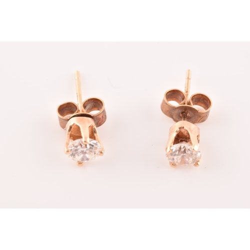 55 - A pair of 14ct yellow gold diamond studs, featuring brilliant cut diamonds with a combined approxima... 