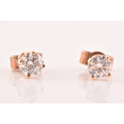 55 - A pair of 14ct yellow gold diamond studs, featuring brilliant cut diamonds with a combined approxima... 