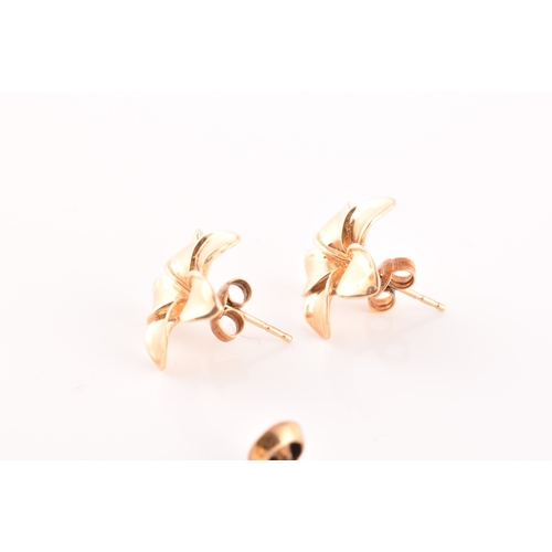 56 - A pair of 14ct yellow gold flower earrings, together with a pair of 9ct yellow gold studs, set with ... 