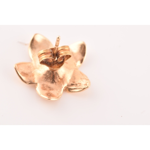 56 - A pair of 14ct yellow gold flower earrings, together with a pair of 9ct yellow gold studs, set with ... 