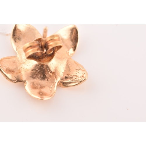 56 - A pair of 14ct yellow gold flower earrings, together with a pair of 9ct yellow gold studs, set with ... 