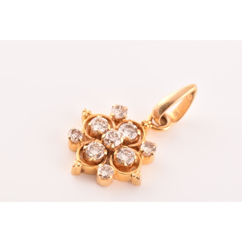 62 - A yellow metal and diamond cluster pendant, set with nine round brilliant cut diamonds, with a combi... 