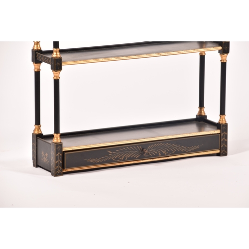 304 - A 20th century oriental design black and gilt wall shelf, the top with pergoda style pediment, three... 