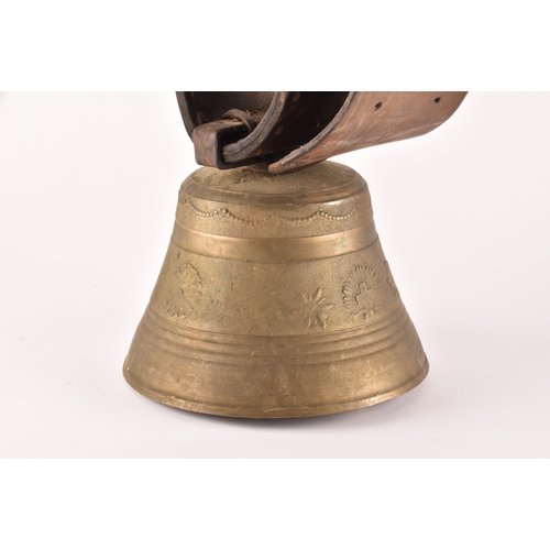 261 - A 19th century Swiss brass cowbell, the bell decorated with flowers, garlands and the Swiss cross, s... 