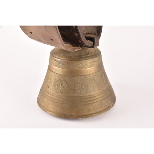 261 - A 19th century Swiss brass cowbell, the bell decorated with flowers, garlands and the Swiss cross, s... 