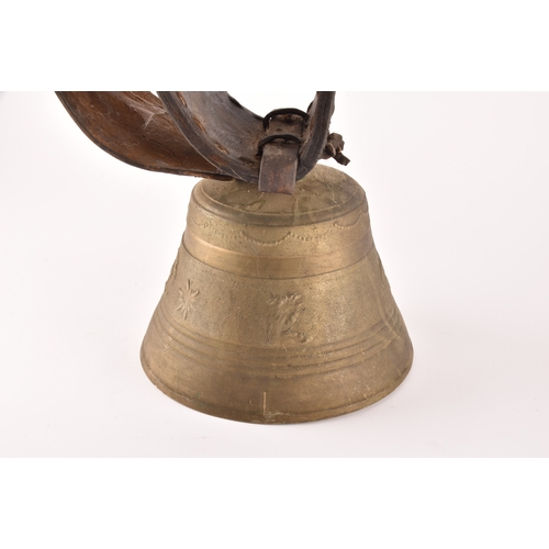 261 - A 19th century Swiss brass cowbell, the bell decorated with flowers, garlands and the Swiss cross, s... 