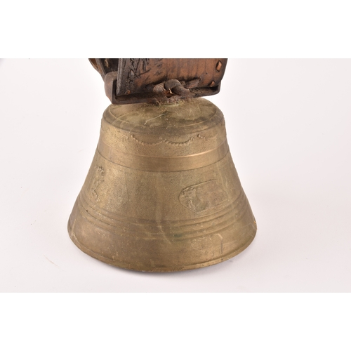 261 - A 19th century Swiss brass cowbell, the bell decorated with flowers, garlands and the Swiss cross, s... 