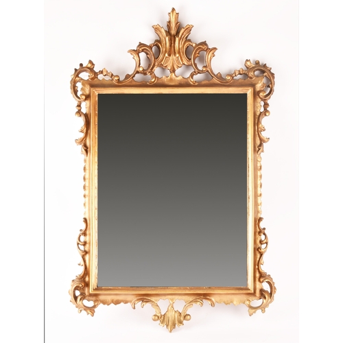 307 - A Rococo style gilt gesso wall mirror, with elaborate scrolled frame and rectangular plate, 79.5 x 5... 