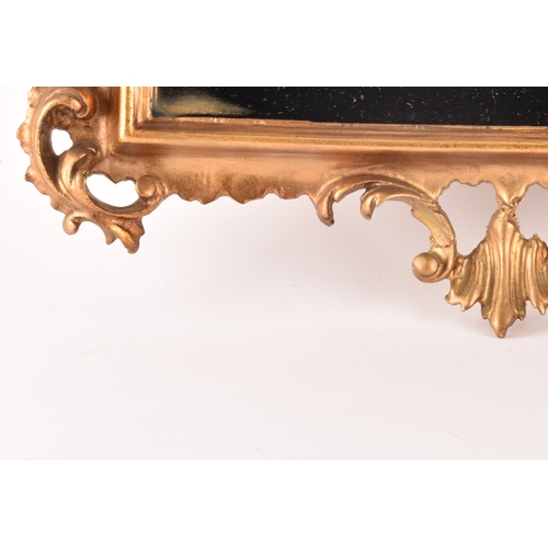 307 - A Rococo style gilt gesso wall mirror, with elaborate scrolled frame and rectangular plate, 79.5 x 5... 