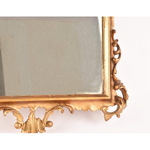 307 - A Rococo style gilt gesso wall mirror, with elaborate scrolled frame and rectangular plate, 79.5 x 5... 