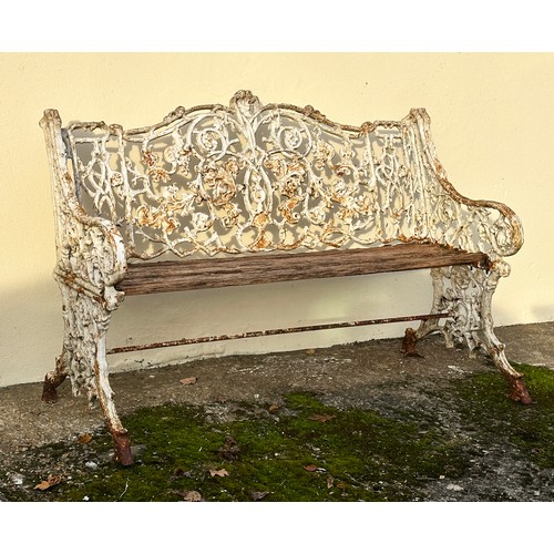 309 - An 19th century cast iron garden bench, the back decorated with scrolling flowers and branches, with... 