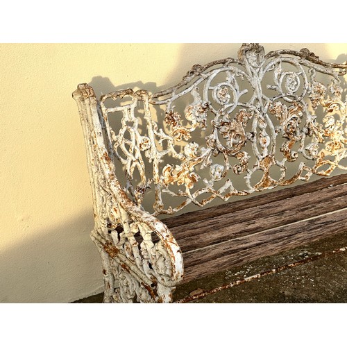 309 - An 19th century cast iron garden bench, the back decorated with scrolling flowers and branches, with... 