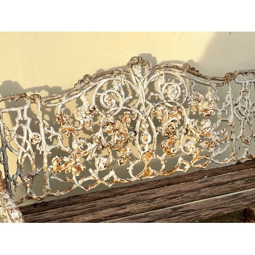 309 - An 19th century cast iron garden bench, the back decorated with scrolling flowers and branches, with... 