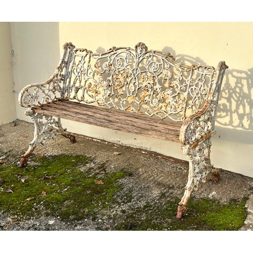 309 - An 19th century cast iron garden bench, the back decorated with scrolling flowers and branches, with... 