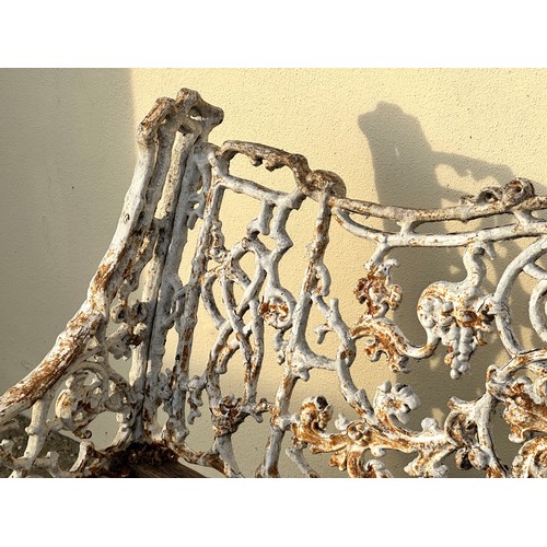 309 - An 19th century cast iron garden bench, the back decorated with scrolling flowers and branches, with... 