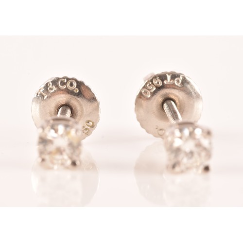 30 - Tiffany & Co. A pair of platinum set, round brilliant cut diamond studs, with a combined diamond... 