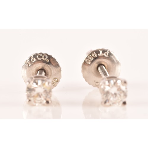 30 - Tiffany & Co. A pair of platinum set, round brilliant cut diamond studs, with a combined diamond... 